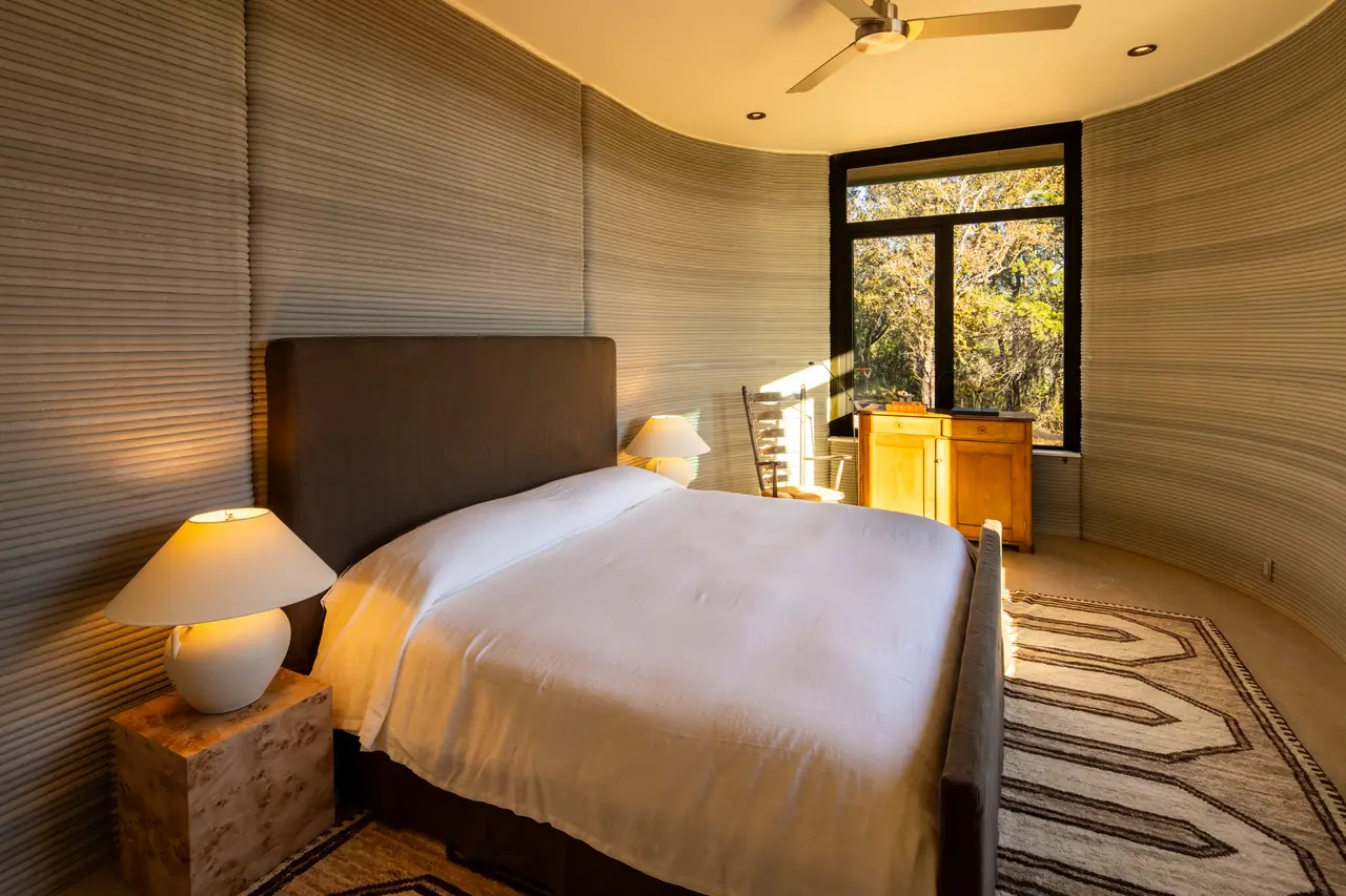 Bedroom with a king bed and a window onto the oaks