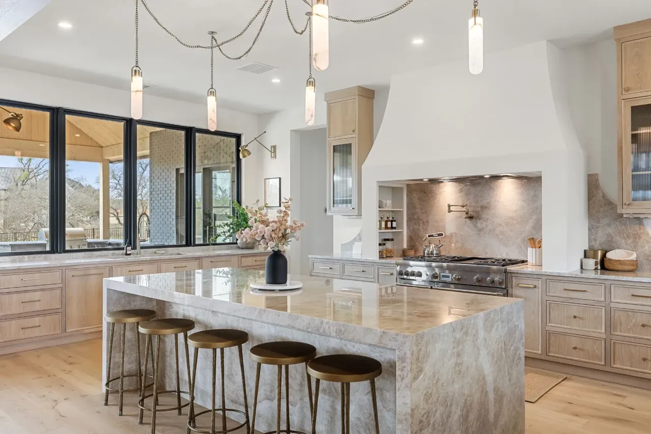 Kitchen with a marble island and bar stools