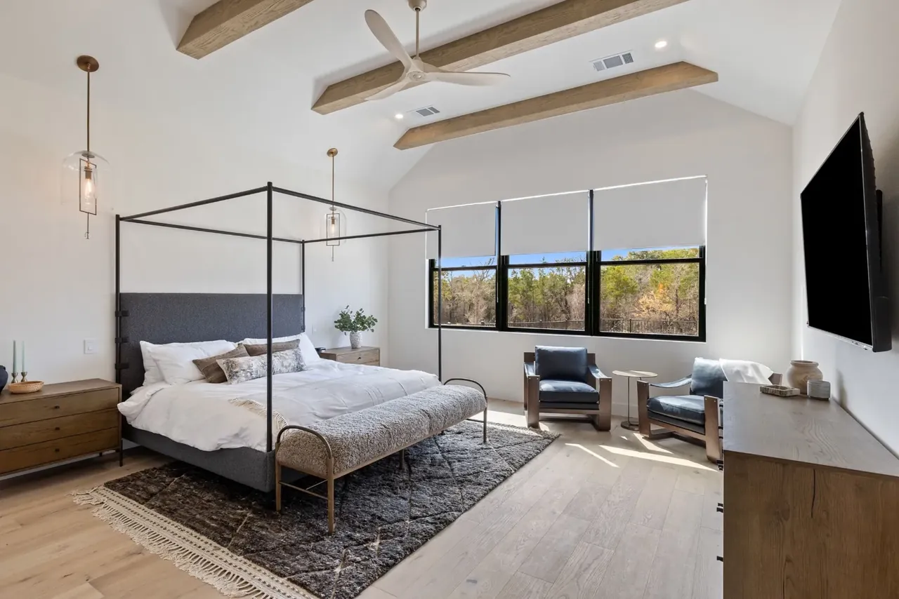 Primary bedroom with a canopy bed