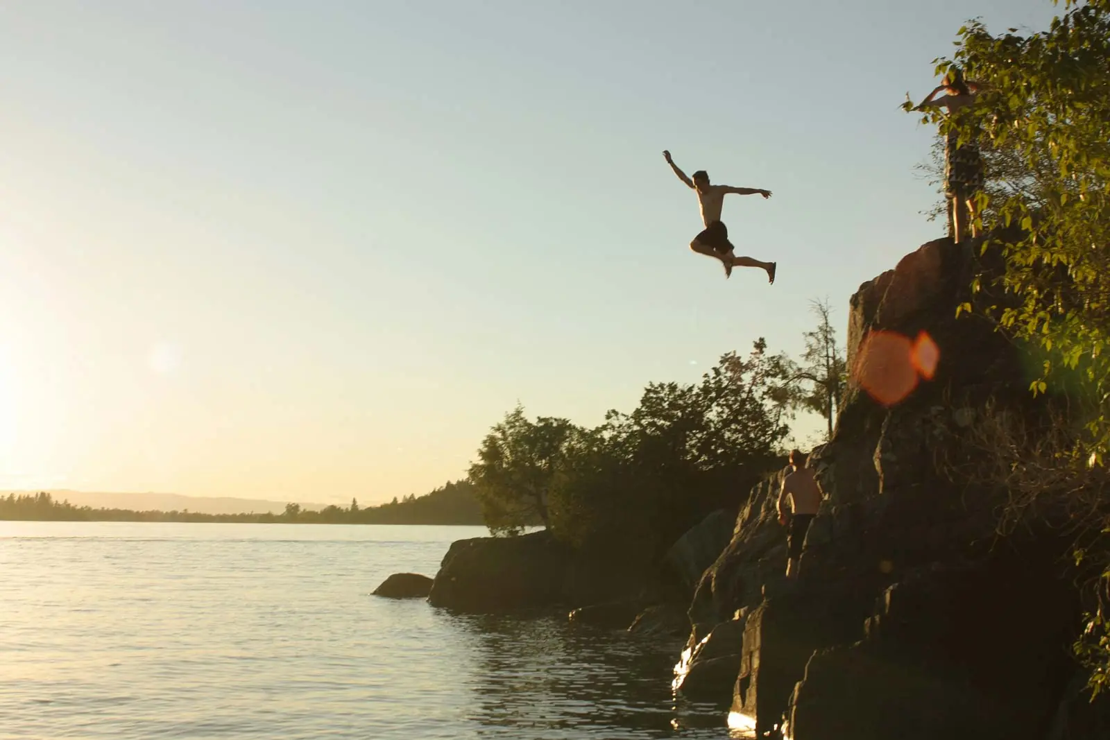 Jumping from the limestone cliffs into Lake Travis at sunset