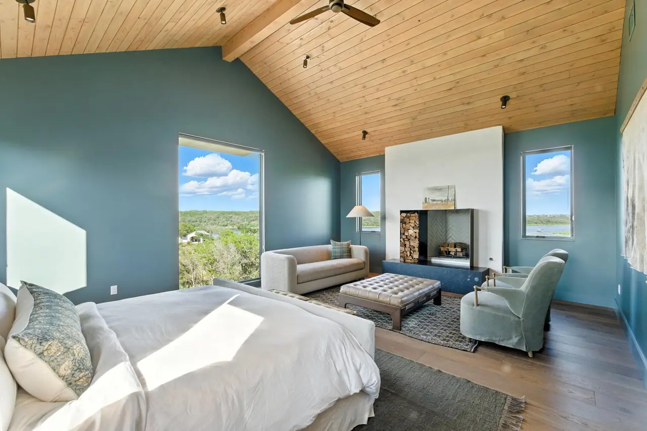 Bedroom with a vaulted wood ceiling and a sitting area