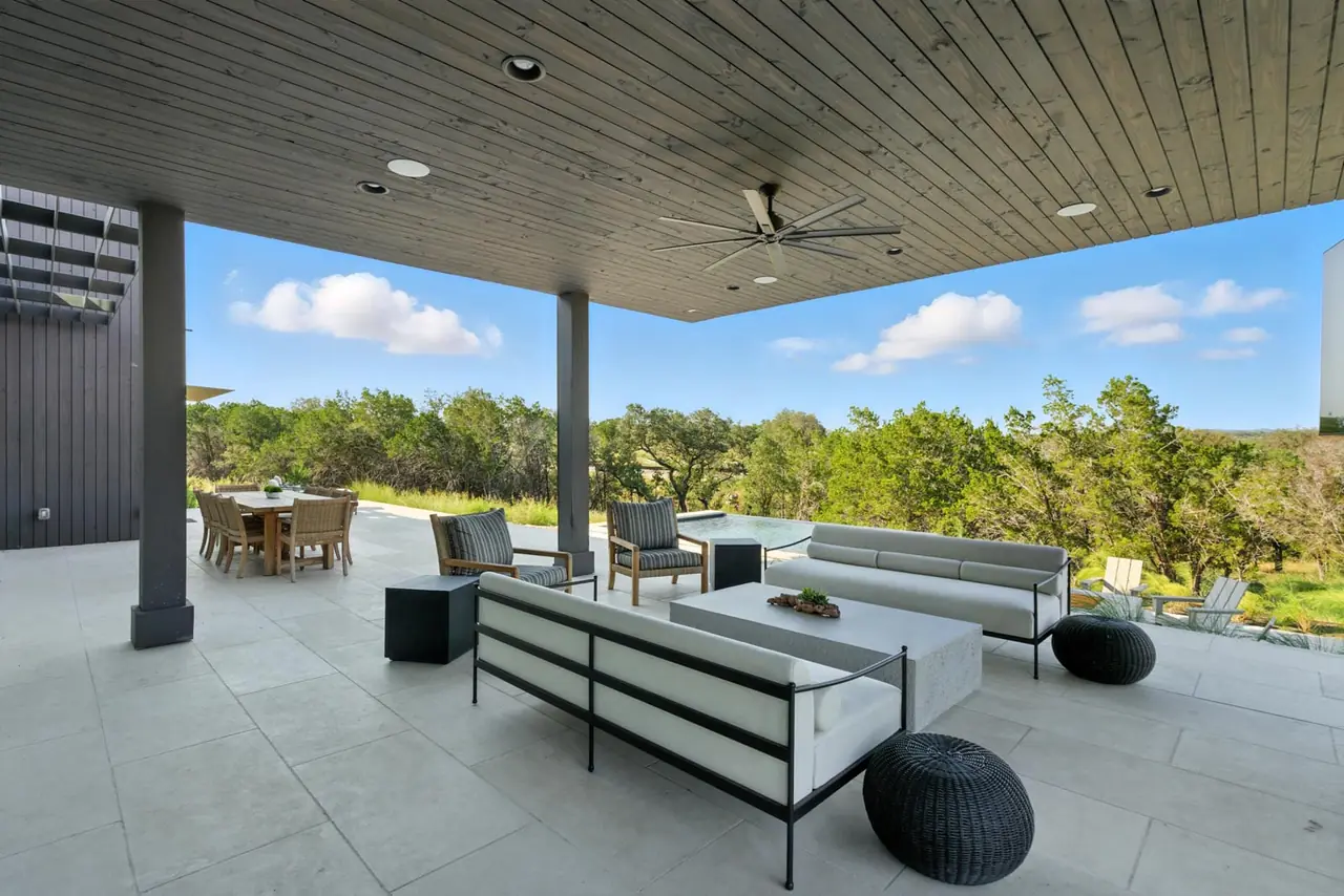 Covered patio with sofas facing the trees