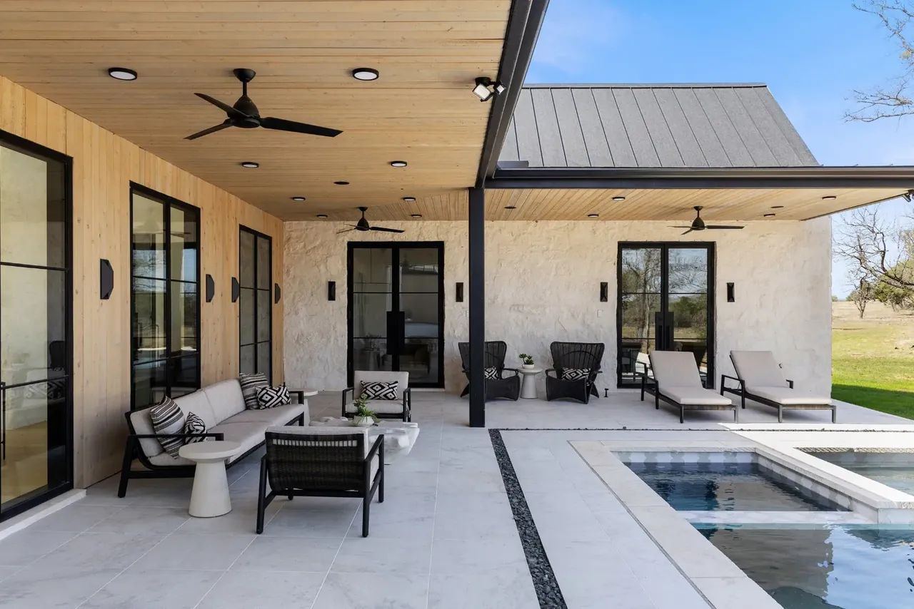 Covered terrace with lounge seating next to the pool