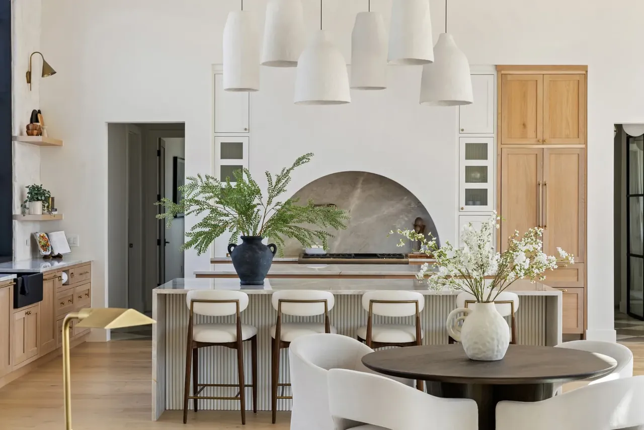 Kitchen with an arched range hood and a breakfast table