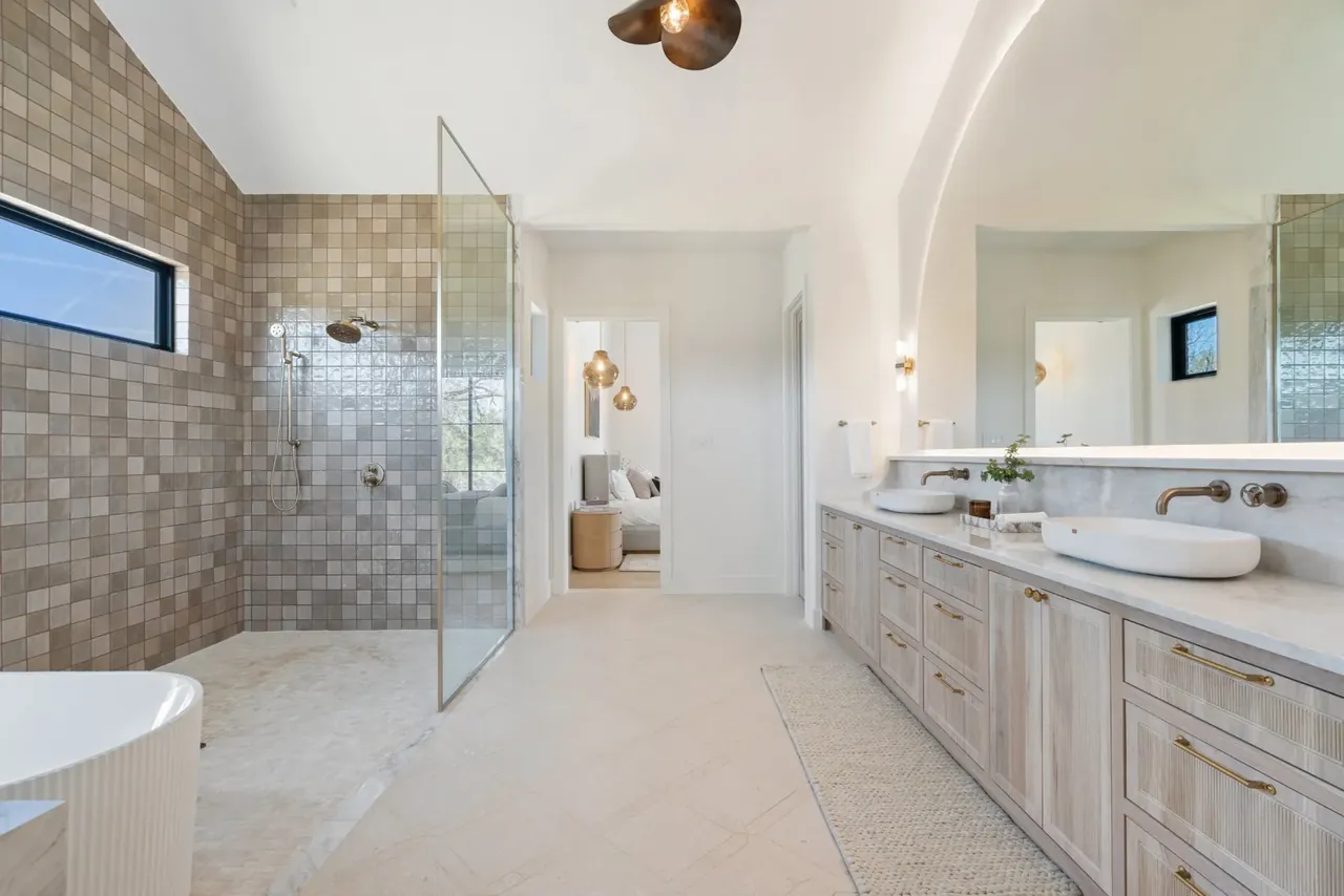 Primary bathroom with a walk-in shower and double vanity